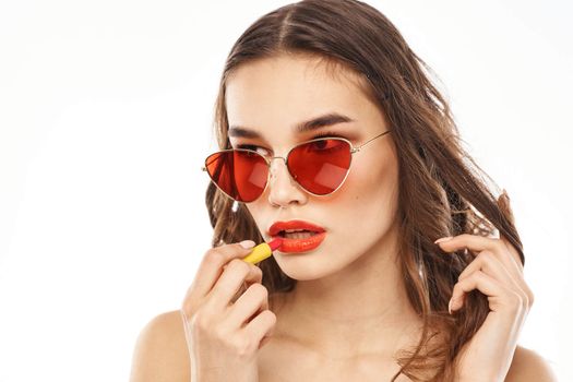 Fashionable brunette in sunglasses with makeup lipstick model. High quality photo