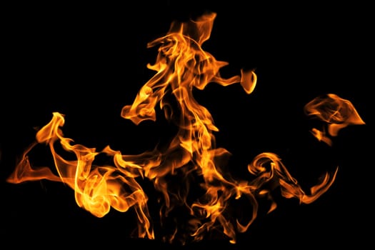 Fire flames on black background isolated. Burning gas or gasoline burns with fire and flames. Flaming burning sparks close-up, fire patterns. Infernal glow of fire in the dark with copy-space