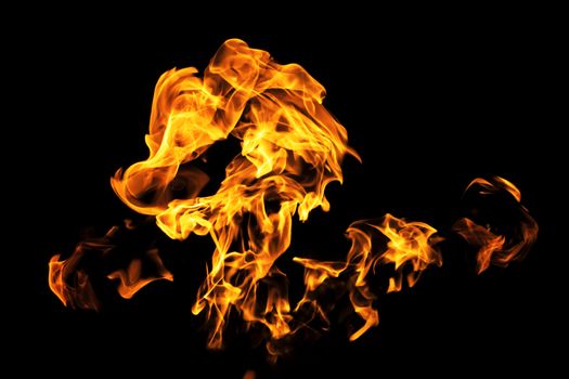 Fire flames on black background isolated. Burning gas or gasoline burns with fire and flames. Flaming burning sparks close-up, fire patterns. Infernal glow of fire in the dark with copy-space