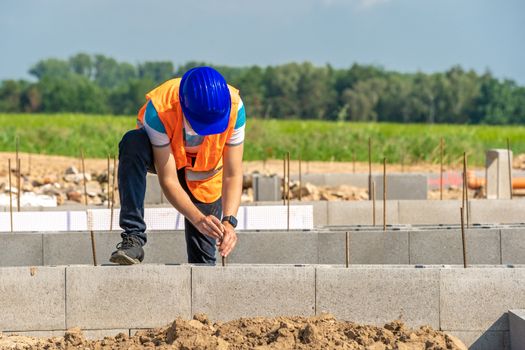 the construction worker builds the foundation of the building.