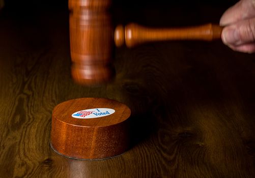 I voted campaign sticker on the gavel being hit by mallet as the concept of judges overruling the rights of voters in the election