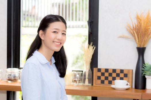 Portrait of beautiful young asian woman happiness sitting at cafe shop, businesswoman is a smile, freelance people concept.