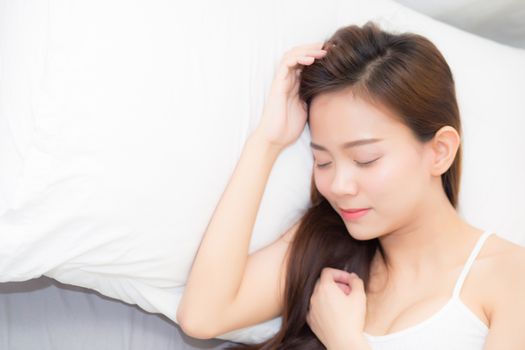 Beautiful asian young woman sleeping lying in bed with head on pillow comfortable and happy. girl with relax for health concept.