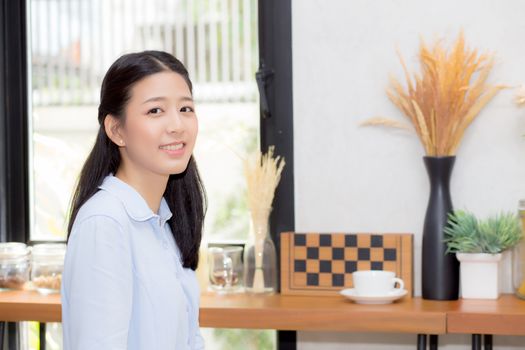 Portrait of beautiful young asian woman happiness sitting at cafe shop, businesswoman is a smile, freelance people concept.