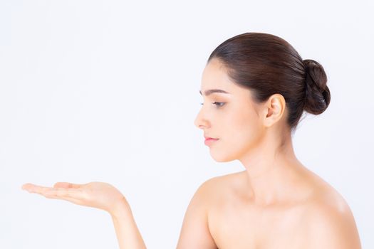 Asian beautiful young woman showing with healthy clean skin presenting something empty copy space on the hand isolated on white background, beauty concept.