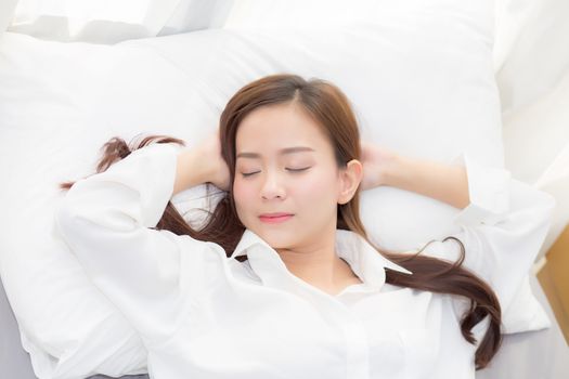 Beautiful asian young woman sleeping lying in bed with head on pillow comfortable and happy. girl with relax for health concept.