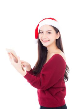 Beautiful of portrait young asian woman in red dress with christmas hat holding tablet isolated on white background, girl with connection digital, communication concept.