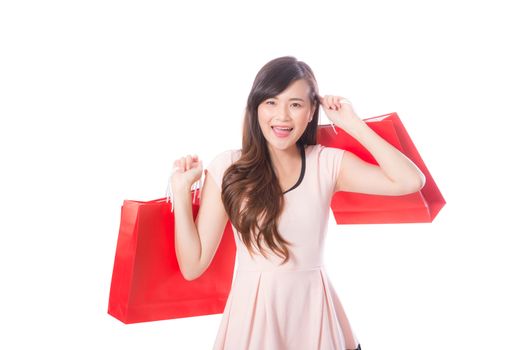 Portrait of asian beautiful young woman holding shopping bag with smile and happy, girl with buying on isolated white background, consumerism concept.