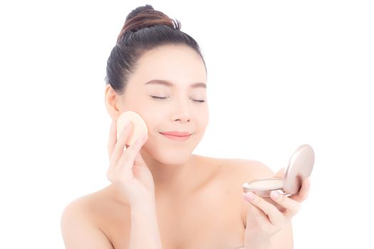 Portrait of beautiful asian woman applying powder puff at cheek makeup of cosmetic, beauty of girl with face smile isolated on white background, wellness and healthcare concept.
