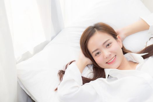 Beautiful asian young woman sleeping lying in bed with head on pillow comfortable and happy. girl with relax for health concept.