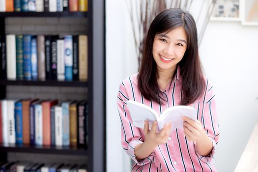 Beautiful of portrait young asian woman relax sitting reading book in living room at home, girl study literature, education and llifestyle concept.