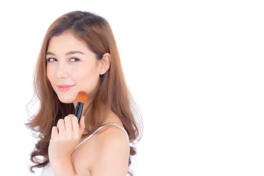 Beauty of portrait asian woman applying make up with brush of cheek isolated on white background, beautiful of girl holding blusher, skincare and cosmetic concept.