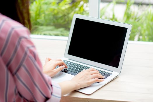 Beautiful of portrait asian young woman working online on laptop computer sitting at coffee shop, professional female freelancer using notebook with connect to internet for distance job.