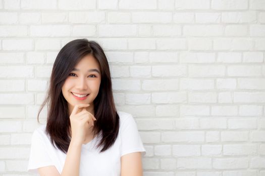 Portrait of beautiful young asian woman happiness standing on gray cement texture grunge wall brick background, businesswoman is a smiling on concrete, business people concept.