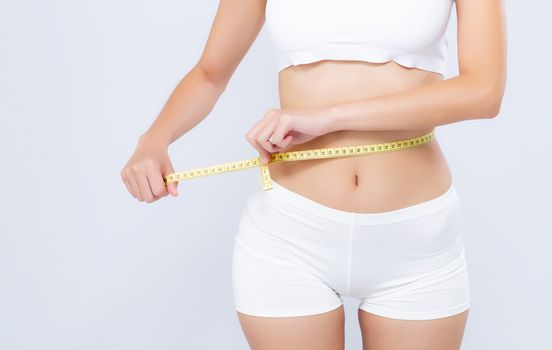 Asian woman diet and slim with measuring waist for weight isolated on white background, girl have cellulite and calories loss with tape measure, health and wellness concept.
