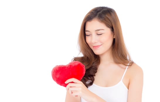 Portrait of beautiful asian young woman holding red heart shape pillow and smile isolated on white background, valentines day, holiday concept.