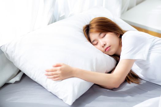 Portrait of beautiful asian young woman sleep lying in bed with head on pillow comfortable and happy with leisure, girl with relax  for health and lifestyle concept.
