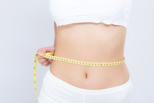 Asian woman diet and slim with measuring waist for weight isolated on white background, girl have cellulite and calories loss with tape measure, health and wellness concept.