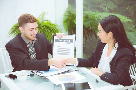 Team businesspeople handshake man and woman with agreement meeting for celebration at office, business marketing success with teamwork and partnership concept.
