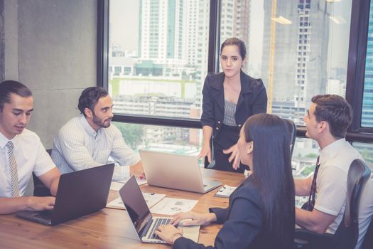 Group of young business team with woman manager standing leader meeting in conference room at modern coworkers office, teamwork and business concept.