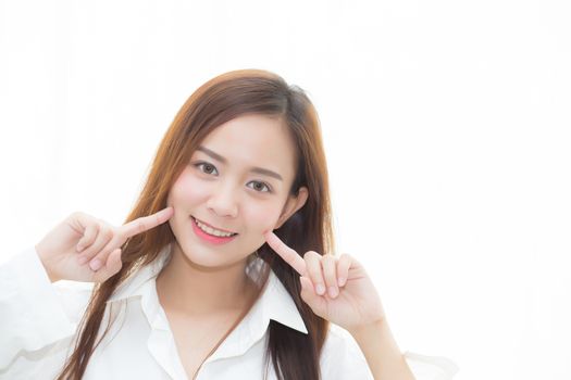 Portrait of beautiful woman makeup of cosmetic, girl hand touch cheek and smile attractive standing the window, face of beauty perfect with wellness, healthcare concept.