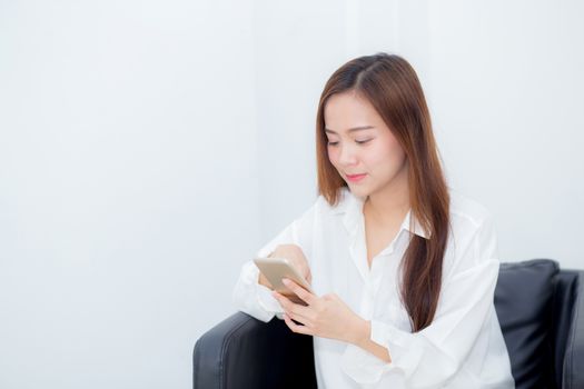 Beautiful of portrait young asian woman smiling sitting relax on the chair, girl using mobile smart phone talking enjoy, communication and social network concept.