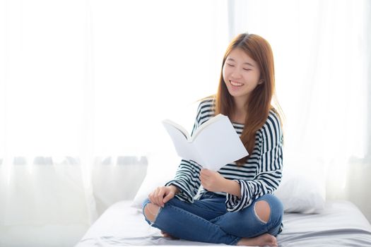Beautiful of portrait young asian woman relax sitting reading book on bedroom at home, girl study literature, education and llifestyle concept.
