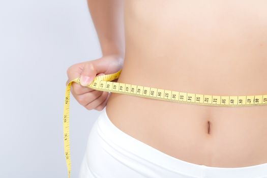 Asian woman diet and slim with measuring waist for weight isolated on white background, girl have cellulite and calories loss with tape measure, health and wellness concept.