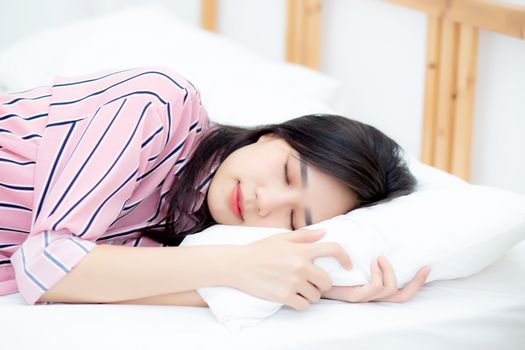 Portrait of beautiful asian young woman sleep lying in bed with head on pillow comfortable and happy with leisure, girl with relax  for health and lifestyle concept.