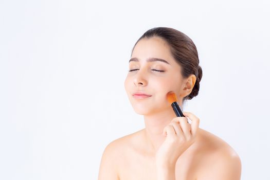 Beauty of portrait asian woman applying make up with brush of cheek isolated on white background, beautiful of girl holding blusher, skincare and cosmetic concept.
