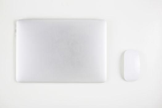 Top view of laptop computer with closed and mouse isolated on white background, notebook or netbook, communication technology concept.