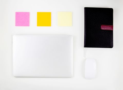 Top view of laptop computer with open display screen monitor, mouse and notepad and note isolated on white background, communication technology concept.