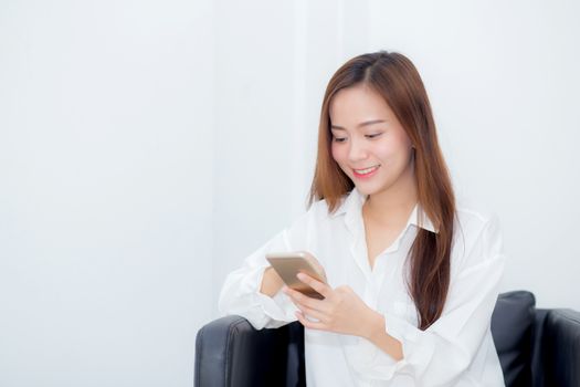 Beautiful of portrait young asian woman smiling sitting relax on the chair, girl using mobile smart phone talking enjoy, communication and social network concept.