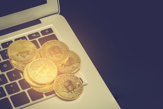 Bitcoin on laptop computer, gold coin with currency digital exchange cash with crypto, technology about money, commercial and finance concept.