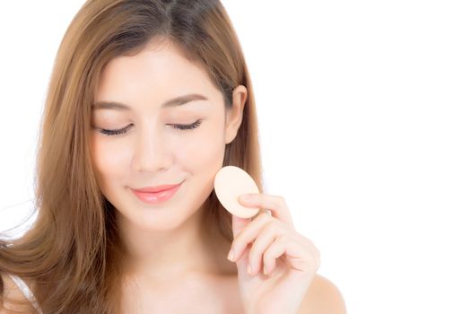 Portrait of beautiful asian woman applying powder puff at cheek makeup of cosmetic, beauty of girl with face smile isolated on white background, wellness and healthcare concept.