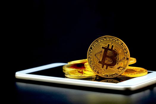 Gold bitcoin on tablet computer isolated on black background, coin money currency virtual digital exchange cash with crypto, technology finance trade, commercial business concept.