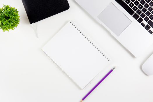Top view of laptop computer with open display screen monitor, diary and mouse and notepad, glasses and pencil isolated on white background, notebook or netbook with keyboard, communication technology concept.