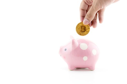 Saving golden bitcoin in piggy bank with hand isolated on white background, Digital currency money trading with cryptocurrency, coin with profit, finance concept.