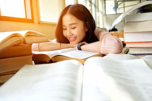 Young woman and studying in library