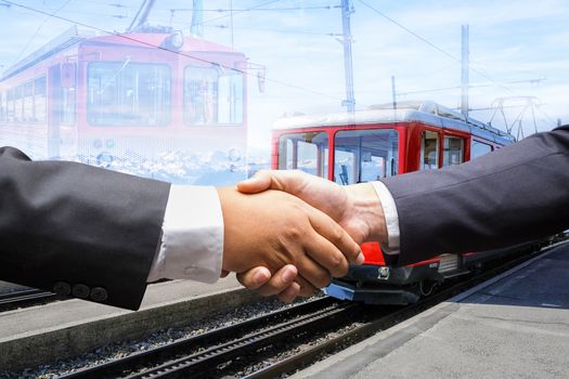 businessmen shaking hands on red train in Switzerland background