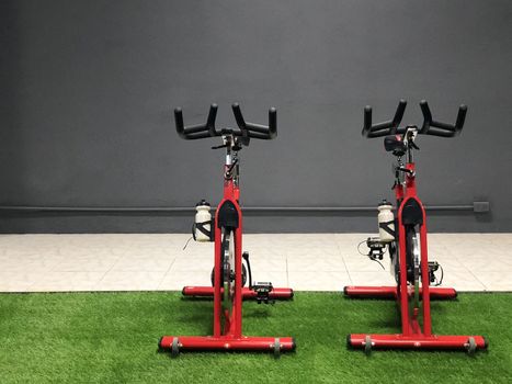 Red fitness cycle wheel in the gym loft style