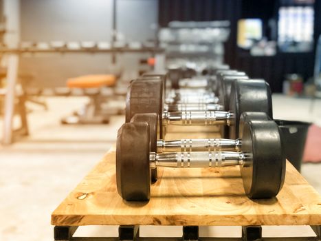 Black dumbbell set. Close up many metal dumbbells in sport fitness center 