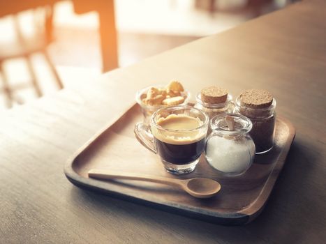 Espresso coffee and cracker on wooden table background