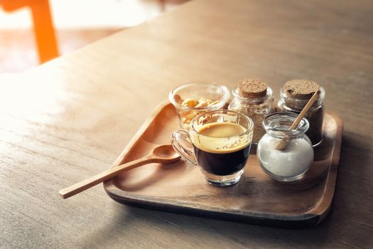 Espresso coffee and cracker on wooden table background