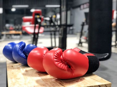 Boxing gloves on wood table in fitness gym