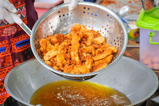 Fried Sweet Potatoes in Colander Over Frying Pan, Thailand Street Food or Thai Snack.