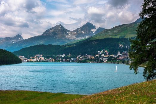 City of St. Moritz with lake also called St. Moritzsee and Swiss Alps in the background in Engadin, Switzerland.