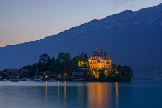 Sunset at the Iseltwald peninsula and forme castle in Switzerland, now Rehabilitation Center of Seeburg. Long exposure.