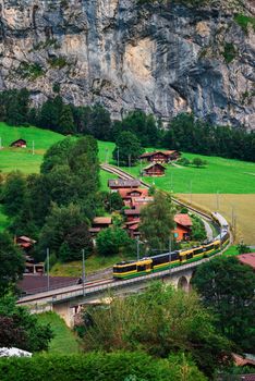 Train going through the Lauterbrunnen valley located in the Swiss Alps near Interlaken, Switzerland.