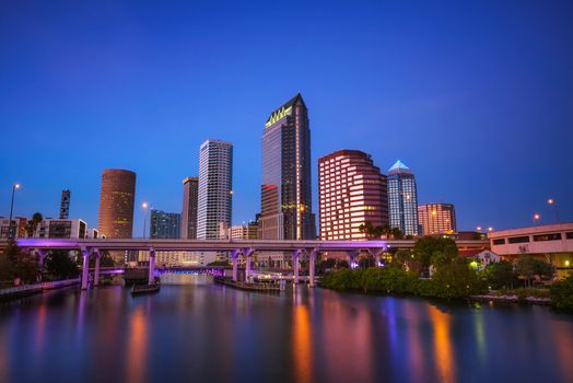The skyline of downtown Tampa after sunset with Hillsborough river in the foreground. Long exposure.